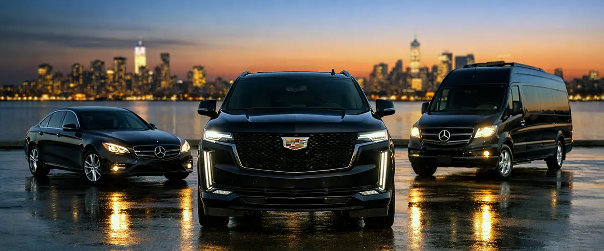 EWR car service fleet lineup at dusk with Mercedes-Benz E350, Cadillac Escalade ESV, and Sprinter against New York City skyline