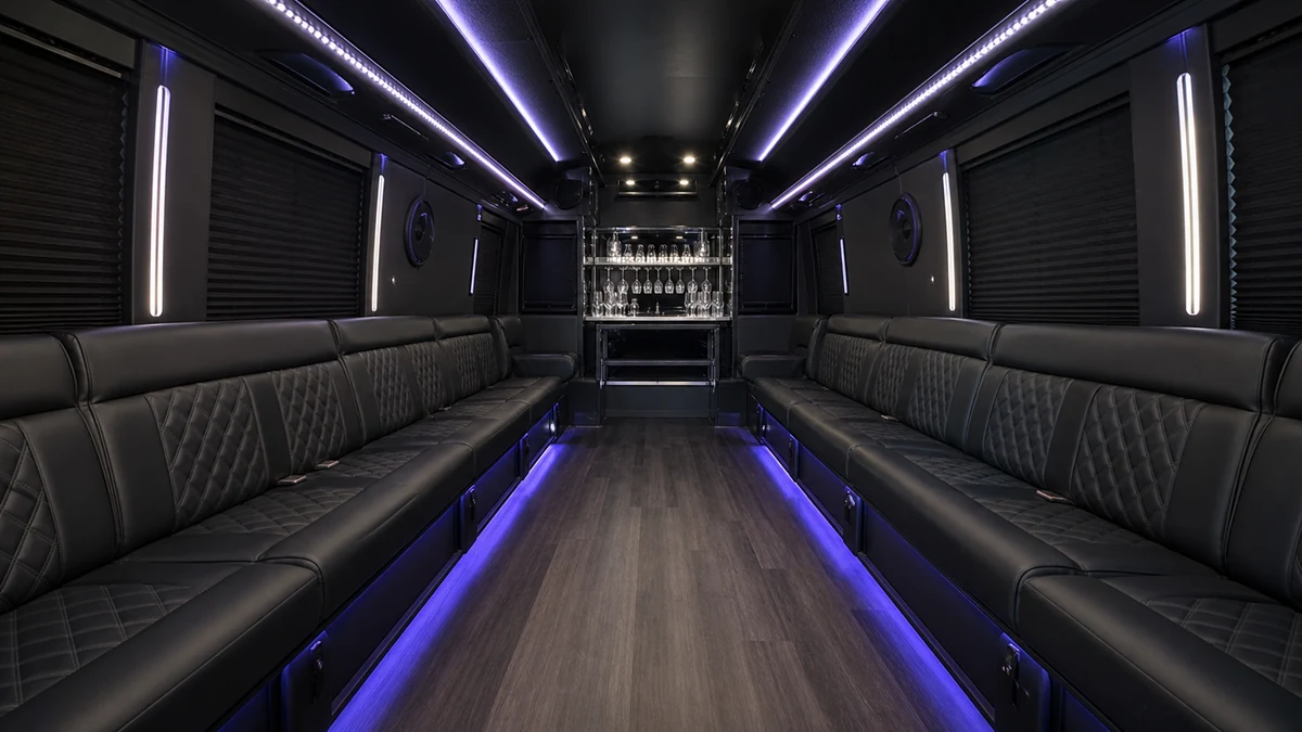 Interior of a party bus limousine with wraparound seating and LED lighting